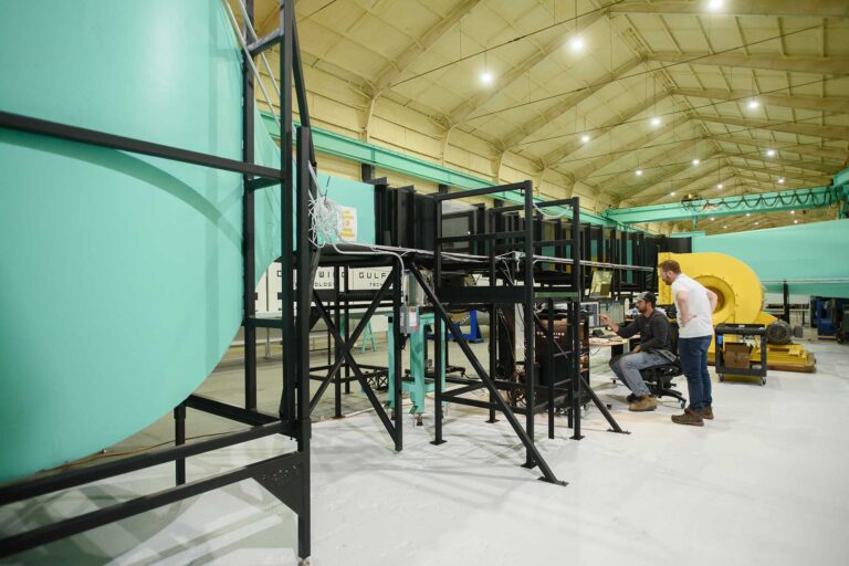 Engineers working on a wind tunnel