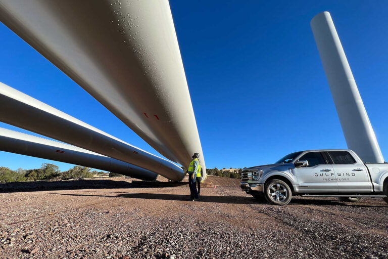 Two engineers inspect wind turbine blades