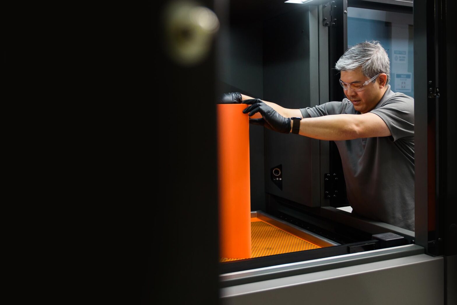 Engineer taking a 3D printed air foil from a 3D printer